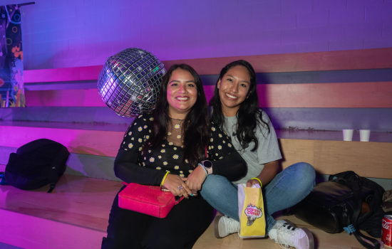 Two students smile for the camera in the SLC