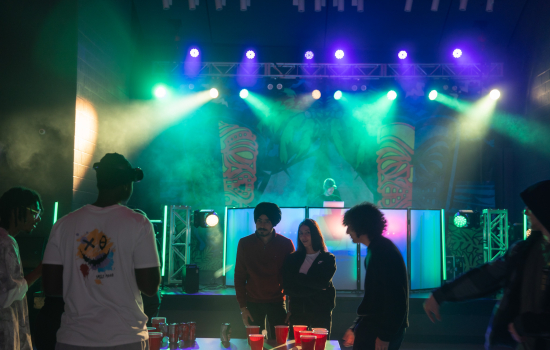 Students gather around the pong table