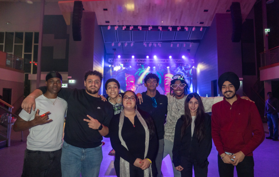 The board and students smile for the camera