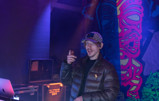 The DJ poses for a photo