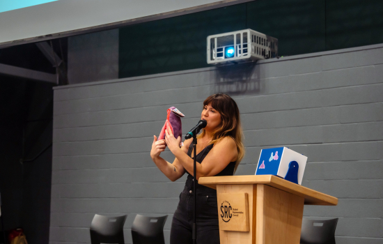 Sabrina Baldini holds a plush vulva up for the audience
