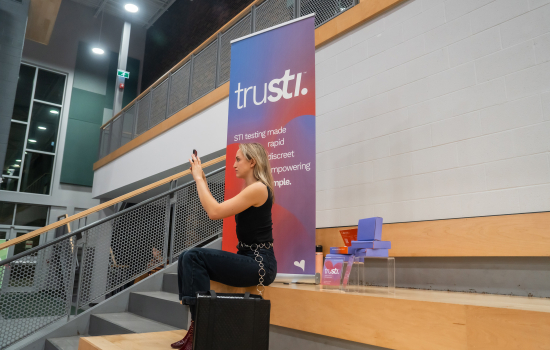 Trusti employee takes a photo on her phone