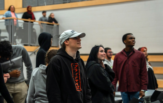 Students stand in the SLC and engage with the speaker