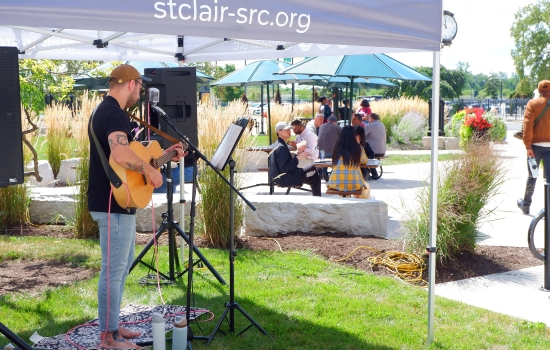 Students enjoy a free BBQ lunch outside with a live acoustic act