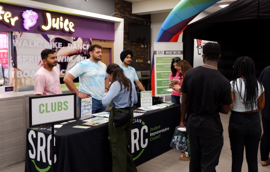 SRC team members assist students at the Clubs table