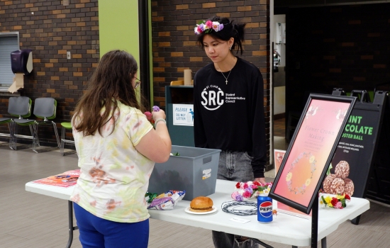 A student enjoys the flower crown making station in promotion of our Welcome Back Fest Coachella event