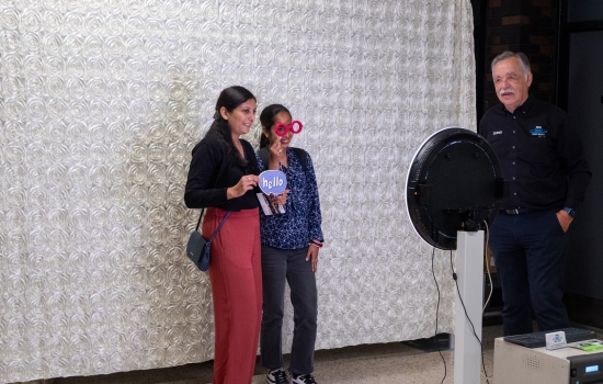 Two students pose with props at the Orientation photo booth