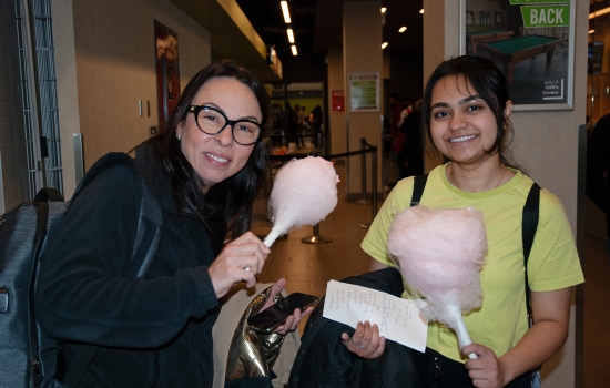 Smiling students pose with their cotton candy
