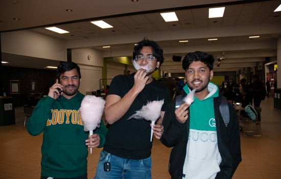 3 students pose with their cotton candy