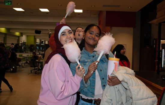 Smiling students pose with their cotton candy
