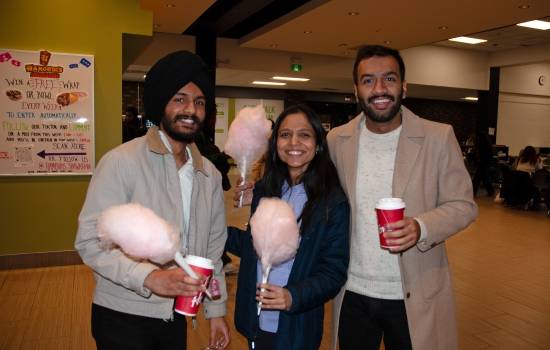 Smiling students pose with their cotton candy