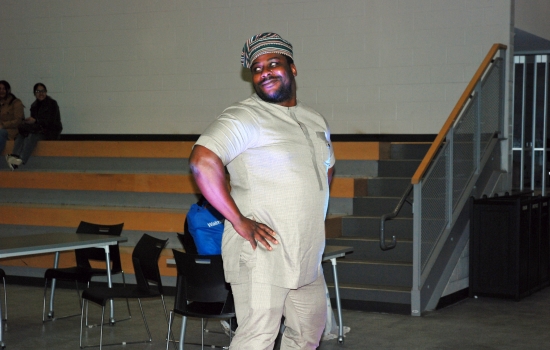 A student models their cultural ensemble on the runway