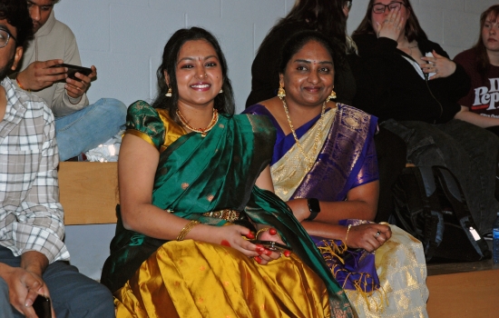 Two students in traditional dress sit in the SLC