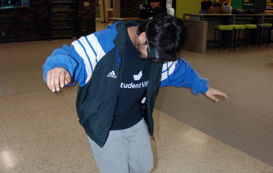 A student attempts to walk a straight line while wearing the impairment goggles