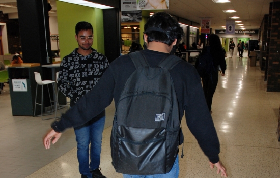 A student attempts to walk a straight line while wearing the impairment goggles