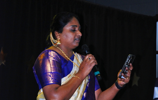 A student in traditional Indian dress speaks to the crowd about what they're wearing