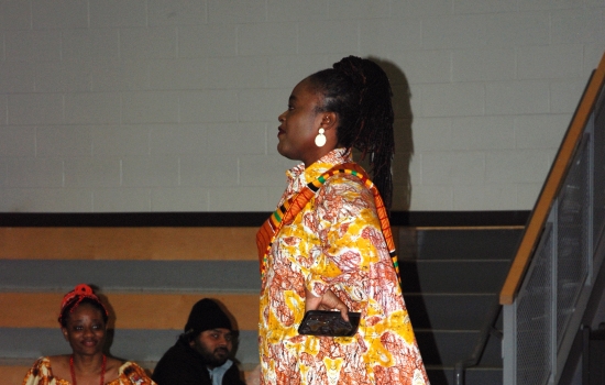 A student models their cultural ensemble on the runway