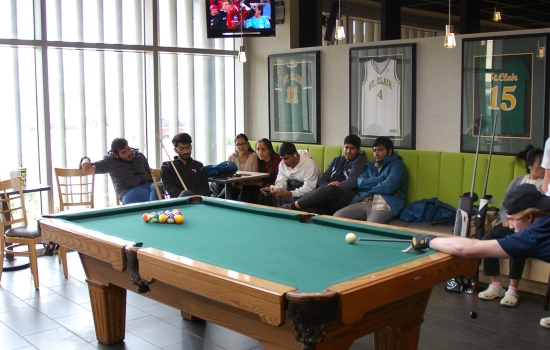 A set pool table with a crowd in the background