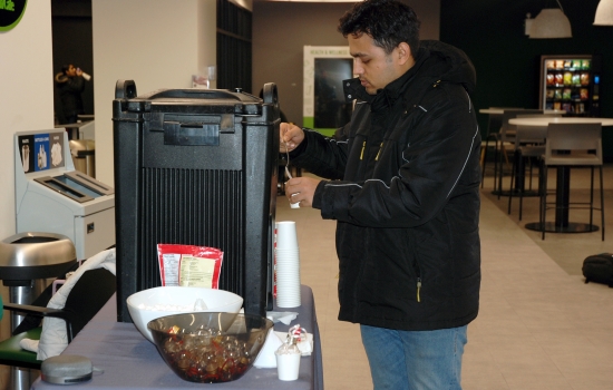 a student pours themself a hot beverage