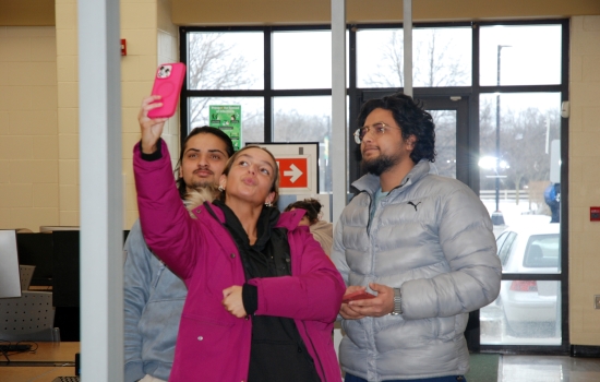 Three students take a selfie together
