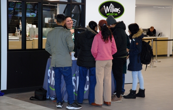 Students crowd around the hot chocolate table