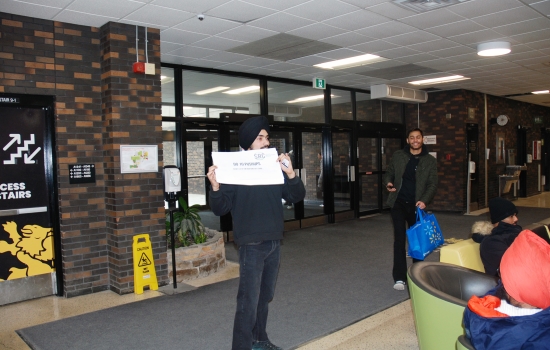 Pratham holds up a sign that says "do 10 pushups"