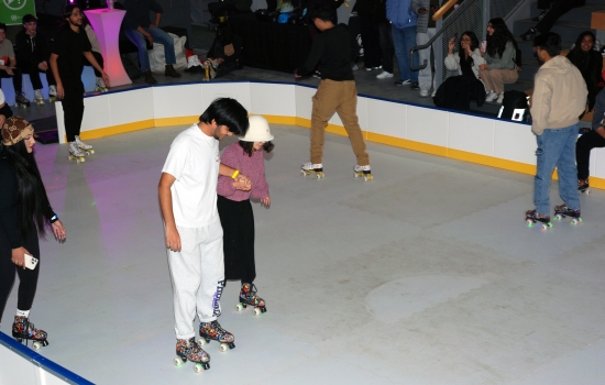 Students help each other balance on skates