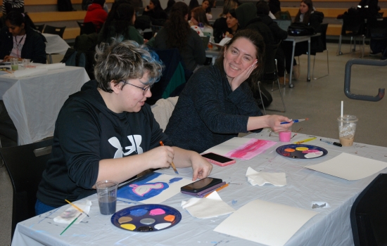Two students work on their paintings