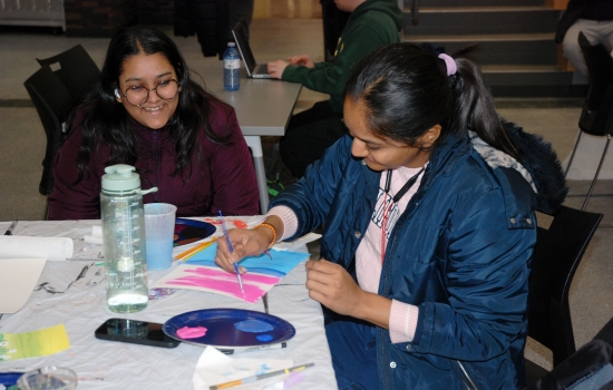 Two students work on their paintings