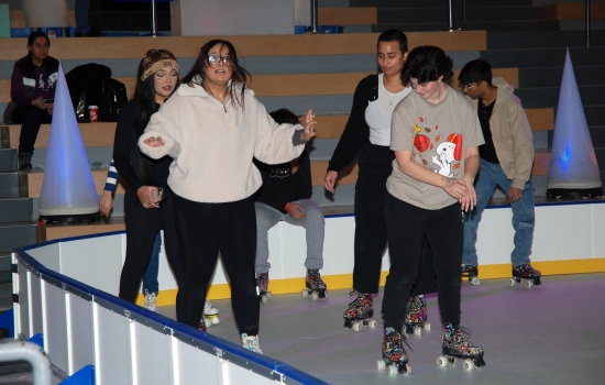 A group of students skate around the SLC