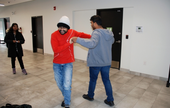 Two students dance together at the event