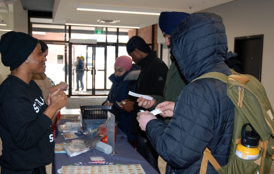 Students engage with Kenney at the booth