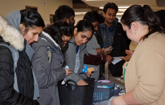 Students crowd around the booth 