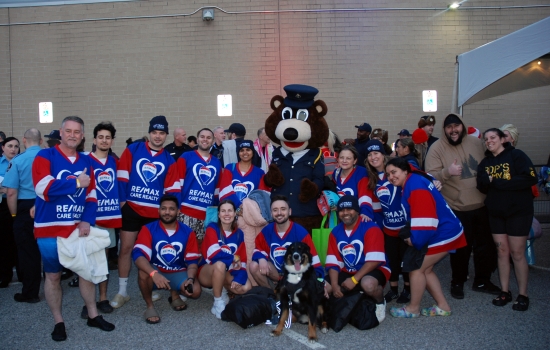 A group of plungers poses with the bear mascot