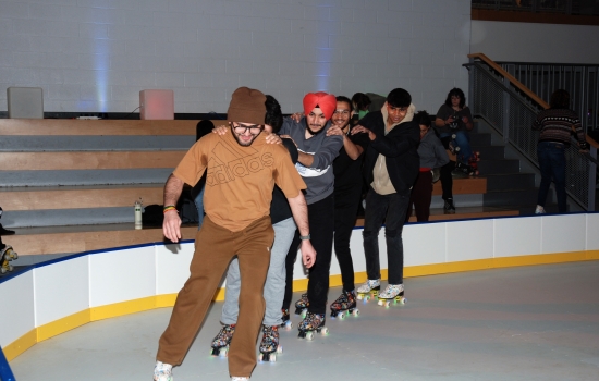 A group of students skate around the SLC
