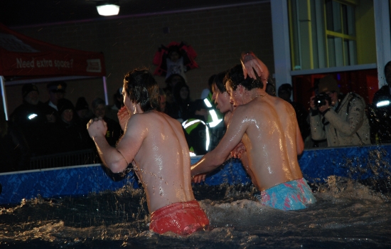 The shirtless plungers rush to get out of the pool