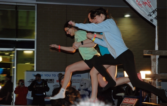 Two plungers in mid air over the pool