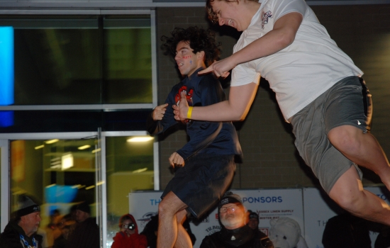Two plungers in mid air over the pool
