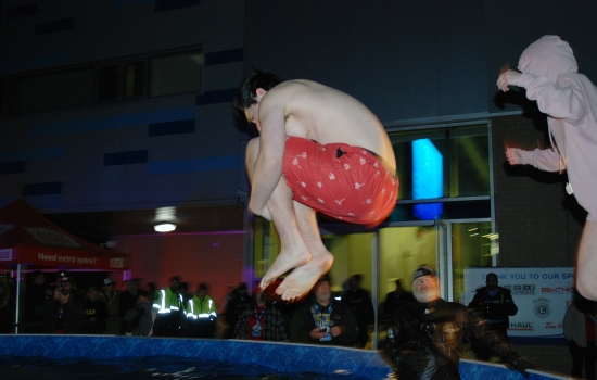 Two plungers in mid air over the pool