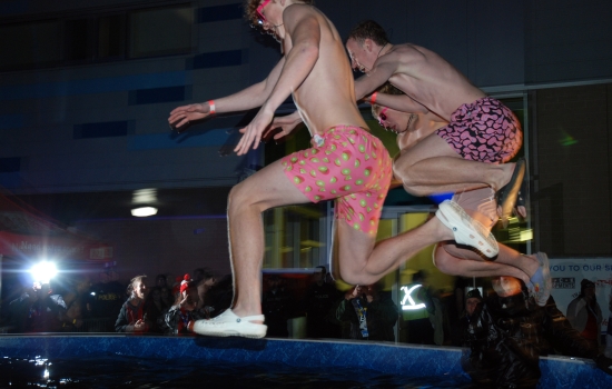 Two plungers in mid air over the pool