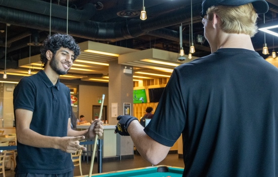Two participants exchange greetings in a pub 
