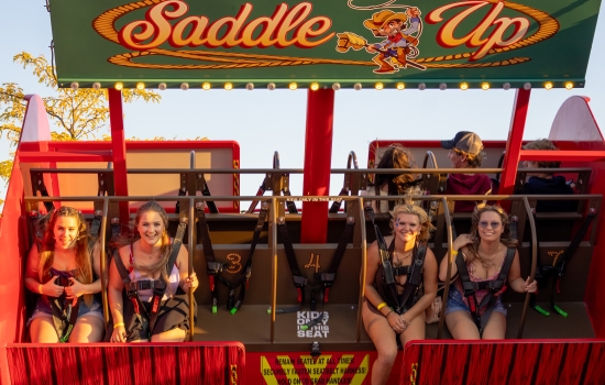 Students ride a swinging ride called Saddle Up