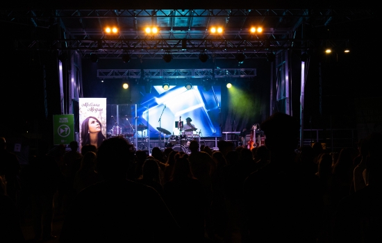 A DJ plays on a large stage