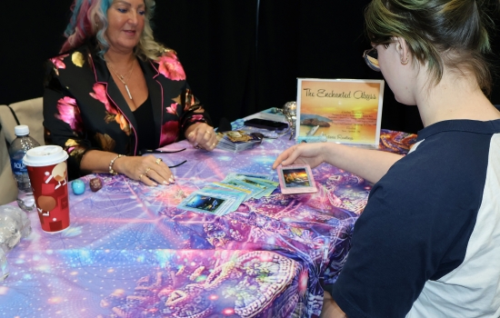 A student holds a tarot card during a reading