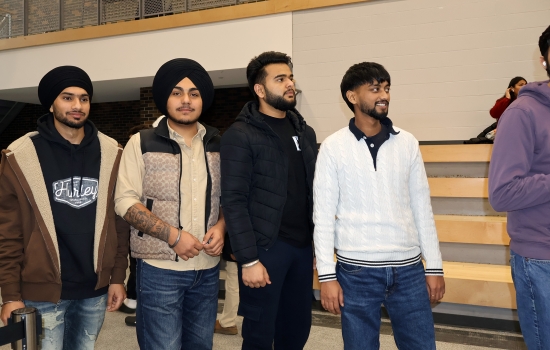 A group of students wait their turn for a reading