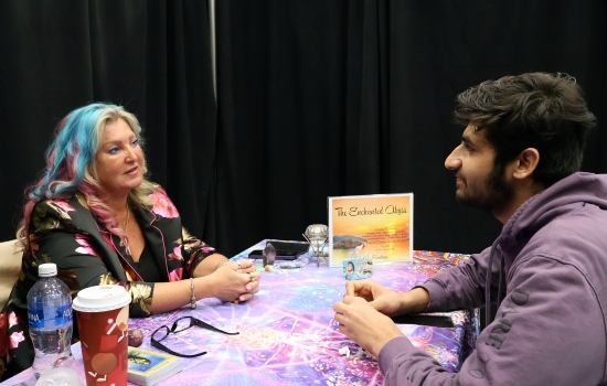 a student sits at the table and chats with the medium