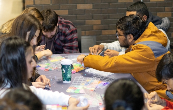 The bracelet-making station full of students