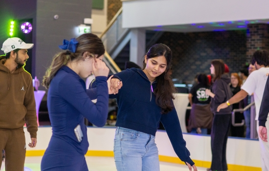 Harnoor assists a student learning to skate