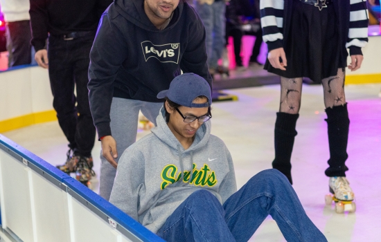 A student falls on the rink