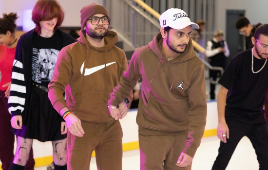 A group of students skate around the SLC